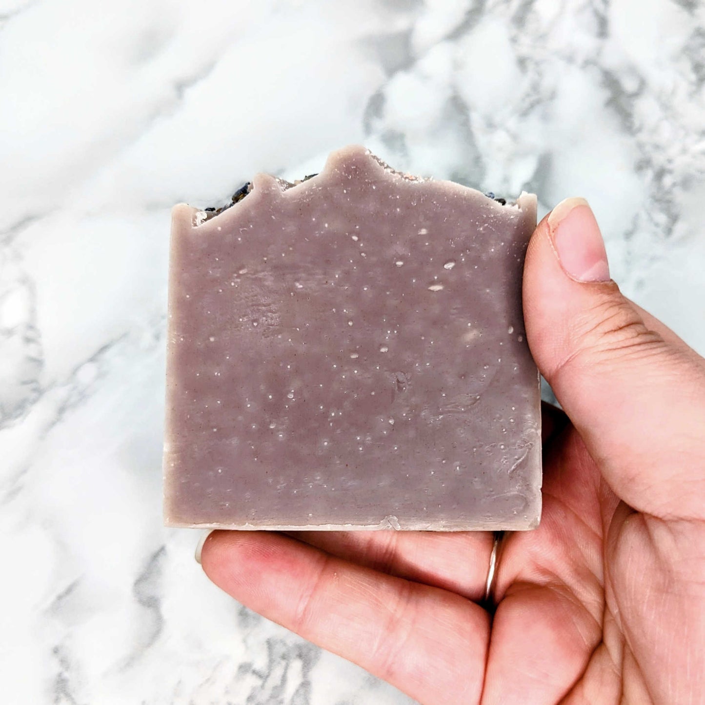 lavender and Himalayan salt soap bar in hand